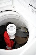 White washing machine filling with water