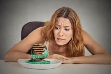 woman craving sugar sweet cookies but worried about weight gain