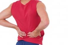 Fit man with injured back on white background