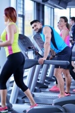 Group of people running on treadmills