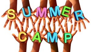 Summer camp kids as multiethnic school chldren with open hands holding letters as a symbol of recreation and fun education with a group working as a team for learning success.