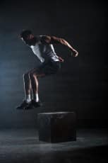 Athlete gave exercise. Jumping on the box. Phase touchdown.