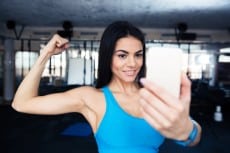 Sports woman making selfie on smartphone