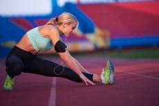 sporty woman on athletic race track