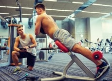 men exercising on gym machine