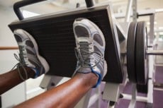 Close up of male weightlifter doing leg presses in gym