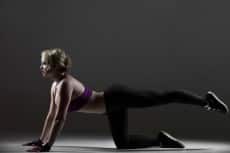Beautiful sporty girl doing leg swings