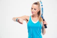 Female tennis player looking on fitness tracker
