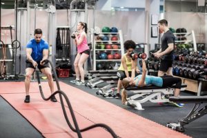 Fit people working out in weights room at the gym