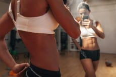 Fitness model taking selfie in gym