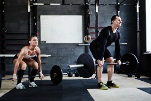 Young man and woman lifting weight