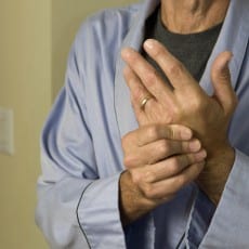 man wringing hands in pain