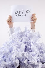 Businessman overwhelmed by paper asks for help