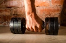 male hand is holding metal barbell