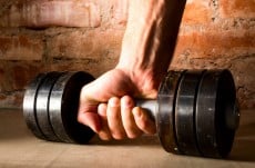 male hand is holding metal barbell