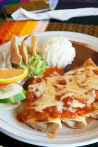 A typical mexican dish, enchiladas with romato and cheese