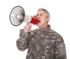 Mature Soldier Shouting Through Megaphone