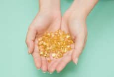 Vitamin Omega-3 fish oil capsules on a hand