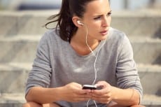 Female Athlete Listening to MP3 Music