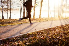 Man running at autumn during sunrise