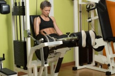 Fitness Woman Exercising Her Legs On Machine