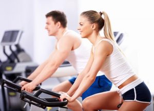 Young people on bikes in a fitness club