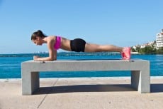 Hispanic woman doing a pilates plank for fitness