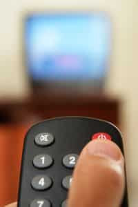 Television screen with tv remote control in foreground.....