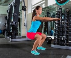 Air squat woman exercise at gym