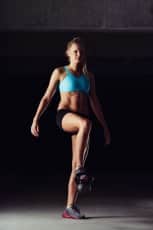 Fit bodybuilder exercising her legs