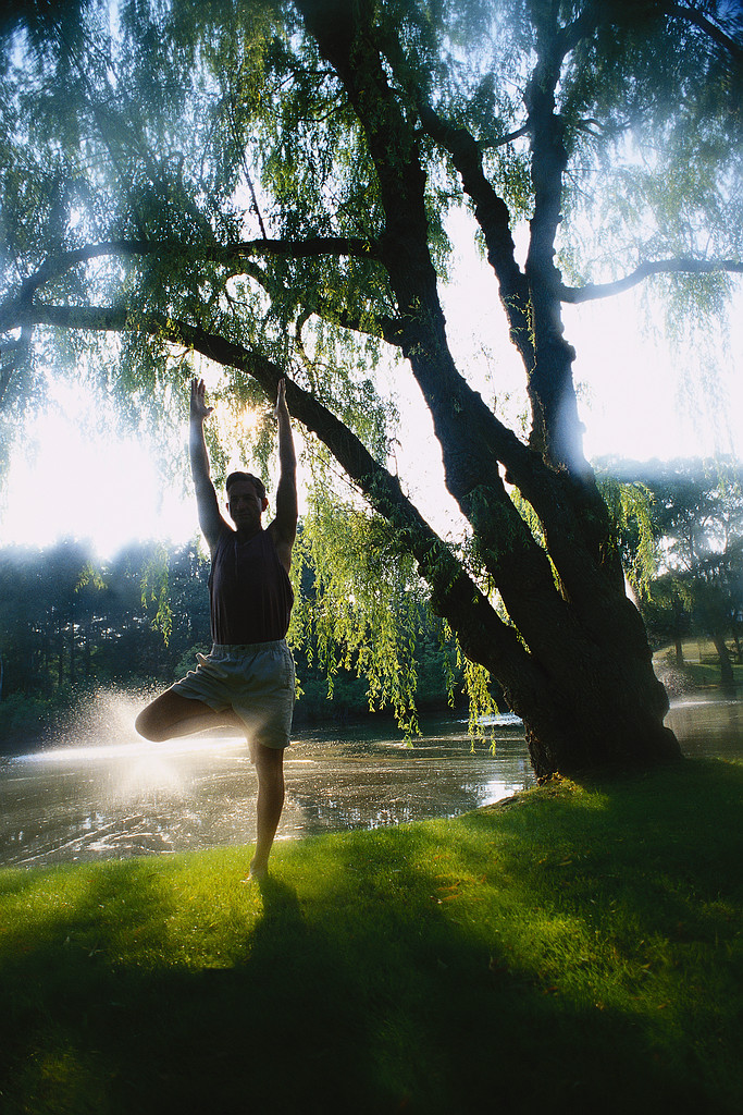 Man Performing Yoga by Lake