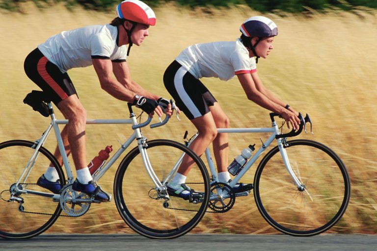 Couple Bicycling on Rural Road