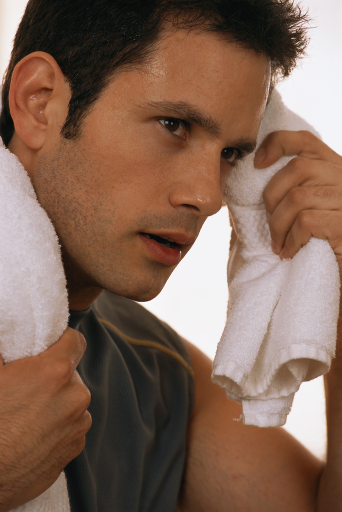 Man Wiping Sweat from Face