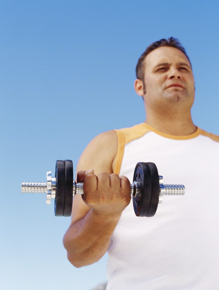 low angle view of a mid adult man exercising with dumbbells