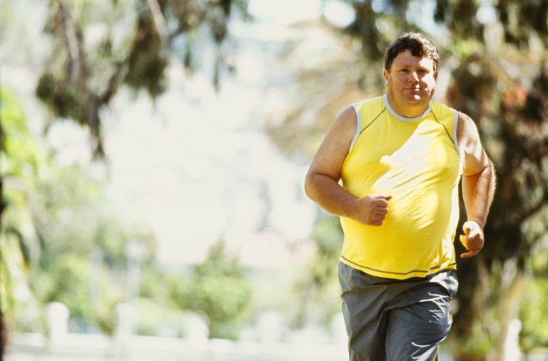 portrait of a mid adult man jogging in a park