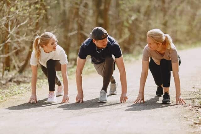 happy-sportspeople-of-different-ages-preparing-to-run-in-4148954