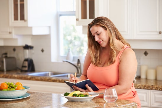 photodune-11189246-overweight-woman-on-diet-keeping-food-journal-xs