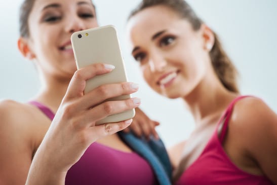 photodune-12223012-happy-girls-using-a-fitness-app-xs
