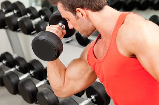 man with weight training equipment on sport gym