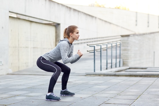 photodune-14463881-woman-doing-squats-and-exercising-outdoors-xs