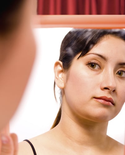 Girl Looking At Herself In The Mirror