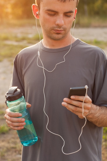 photodune-14711772-man-setting-the-music-playlist-for-the-workout-xs1