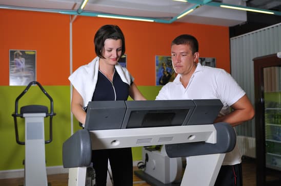 Young woman  working out with coach