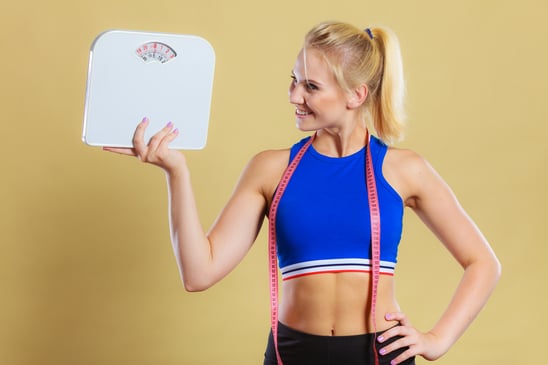 photodune-18138072-sporty-happy-woman-with-scale-weight-loss-xs
