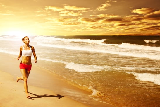 Healthy woman running on the beach