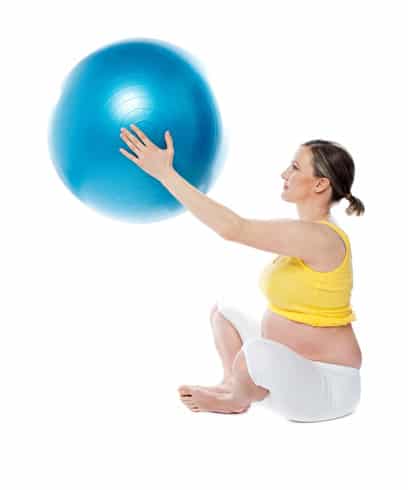 Attractive pregnant lady practicing yoga