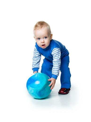 Little boy with the ball on white