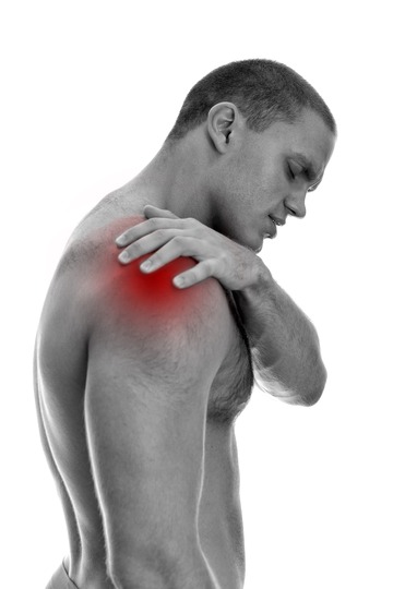 Young man suffering from pain in his shoulder. Isolated on white. black and white