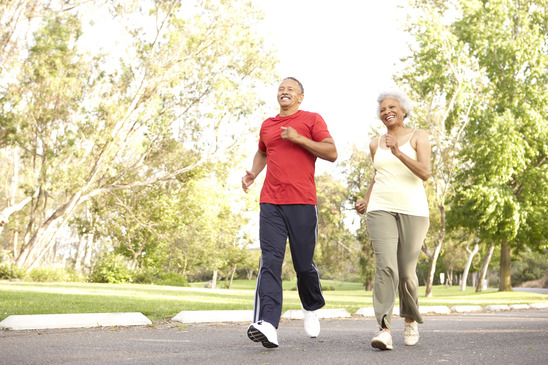 Senior Couple Jogging In Park