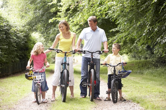 Family riding bikes in countryside